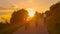 SUN FLARE: Golden evening sun rays shine on group of friends riding e-bikes.