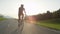 SUN FLARE: Young athlete rides his bicycle through picturesque summer nature