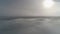 Sun through fog. Antarctica aerial drone flight.