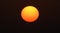 The sun, a giant orange ball in the sky