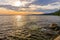 The sun goes over the horizon over the water space of the large Onega Lake with fresh clean water.