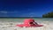 Sun hat and sunglasses on tropical beach