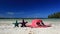 Sun hat and sunglasses on tropical beach