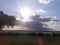 The sun hiding behind the clouds over a Texan lake