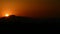 Sun hiding in the mountains at sunset in timelapse