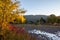 Sun highlights the autumn colored trees along the Naches River.