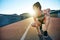 Sun highlights kneeling female jogger