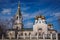 The sun illuminates a church dome on a cloudy sky background