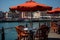 Sun kissed coastal promenade vibrant outdoor dining and leisurely activities in a charming setting