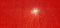 Sun or lamp through red blackout curtains. Bright red background with a glowing circle. Counter light