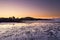 The sun lights up the sky behind the hills along the South Scottish coast at Rockcliffe