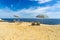 Sun loungers on a beach underneath a parasol