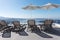 Sun loungers and parasol on the terrace overlooking the Mediterranean in Oia