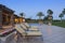 Sun loungers in patio at poolside outside luxurious manor house