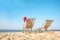 Sun loungers and Santa`s hat on beach, space for text. Christmas vacation