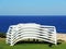 Sun loungers stacked with the background of the sea