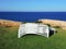 Sun loungers stacked with the background of the sea