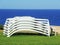 Sun loungers stacked with the background of the sea