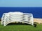 Sun loungers stacked with the background of the sea