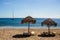 Sun loungers and straw umbrellas from the sun on the beach. Nature.