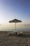 Sun loungers and sunshade on beach