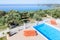 Sun loungers on terrace with swimming pool near sea