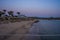 Sun loungers with umbrella on the beach, sunrise. Sunrise on a tropical beach with umbrellas, sun loungers and warm sea