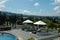 Sun loungers with umbrellas beside the pool at Amen Restaurant Puncak Bogor