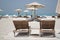 Sun lounges and sun shades on an idyllic white sand beach