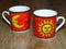 The sun and the moon on two fine porcelain ware tea coffee cups.