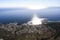 Sun over the ocean, water glare and a view of one of the districts of Cape town