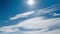 Sun over white clouds at blue sky timelapse aerial view. Bright light sun shine at fluffy cloudy day