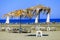 Sun protection umbrellas blown by the wind on the beach