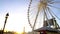 Sun ray penetrating giant construction of observation wheel, theme park, Paris