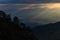 Sun rays breaking through the clouds over a mountain landscape