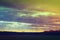 Sun rays through clouds above fields in Iowa before sunset