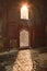 Sun rays create dramatic light and shadow inside of the humayun tomb memorial at winter foggy morning