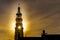 Sun rays through the Lange Jan Toren Long John Tower of the medieval Abbey from the Sun setting behind the tower in MIddelburg