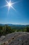 Sun rays over the Adirondack mountain range from the summit of Clark Mountain