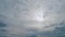 Sun rays radiating from behind a cloud obscuring the sun. Sun rays through the cloud on dark sky. Time lapse.