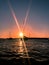 Sun rays reflecting on sailboats at sunset