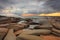 Sun rays, rocks and storm clouds