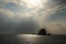 Sun rays shining on small deserted island in Andaman sea