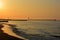 The sun rises at dawn, and the red color is reflected on the sea in its wooden piers