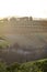 Sun rising on a vineyard landscape in Tuscany, Italy