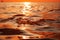 Sun\\\'s abstract orange hues dance on the water, creating stunning reflections