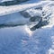 The sun\\\'s rays are refracted in crystal clear pieces of ice. winter landscape. A piece of ice and the sun on a winter lake