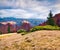 Sun`s rays are rolling down the mountain slopes of the autumn Carpathians. Gloomy morning view of the mountain valley. Beauty of