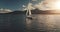 Sun sailboat at ocean bay water reflection aerial. Summer cruise at green mountains island of Arran