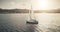 Sun seascape with white sailboat aerial. Sunlight over sail boat at ocean bay reflection. Sea coast